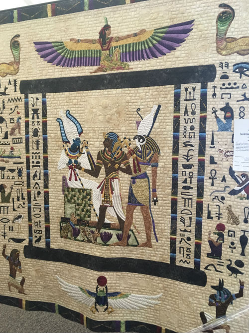 An applique done of a tomb painting depicting the Judgment of Osiris. Extraordinary work in piecing and applique.