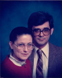 A picture of Mom shortly before her 40th birthday, along with my dad. She’s wearing a red dress, giant glasses, and has her hair pulled back in a bun. Dad is wearing a brown suit and has dark-ish glasses. This is how I remember them from when I was very young. I wasn’t yet born at this point.