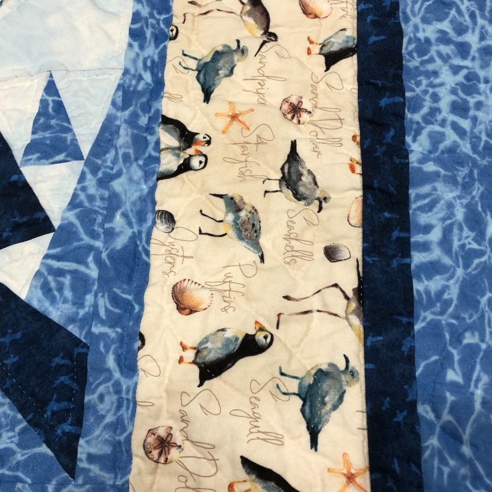 A border of shore birds and shells. Seagulls, sandpipers, puffins… and then also shells and starfish! It’s got the same twisted border but wider.