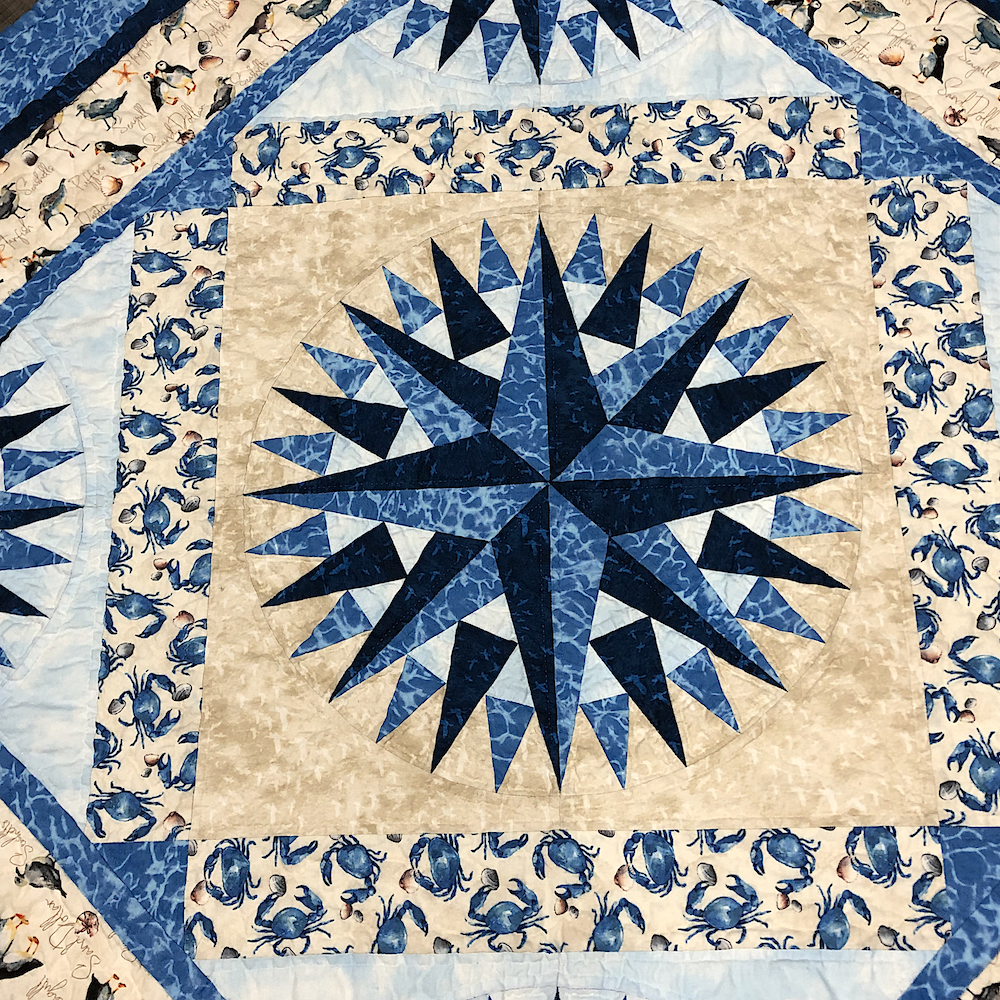The center medallion. You can kind of maybe see that the cream has angled lines through it. The crab border is so dang cute.