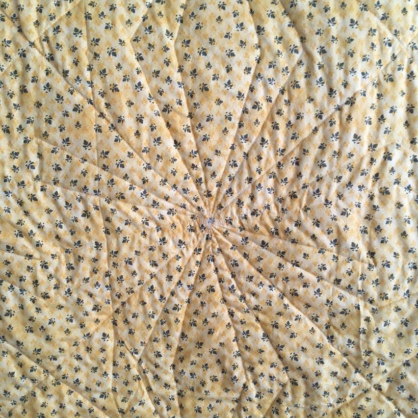 A closeup of the quilting, showing an almost spider-like angled pattern on the backing