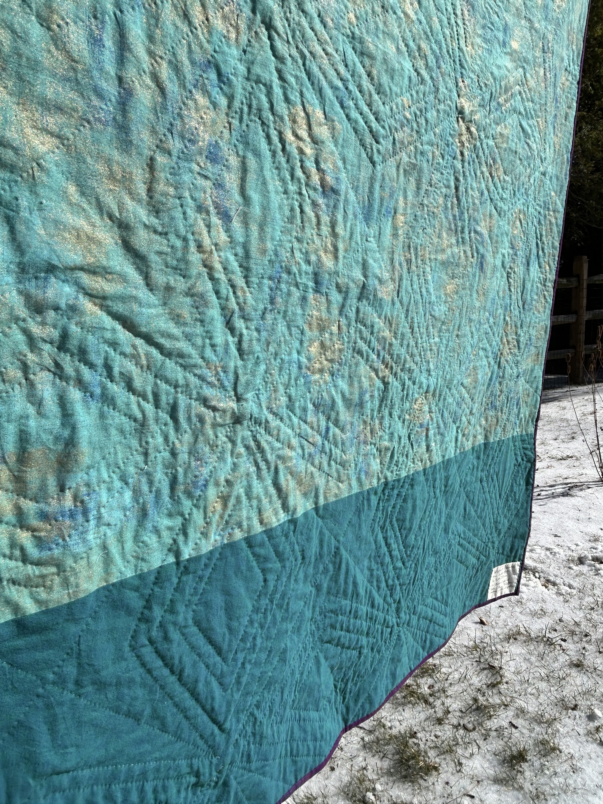An angled view of the back with stitching a little more visible. The texturing created by the diamonds is especially visible.