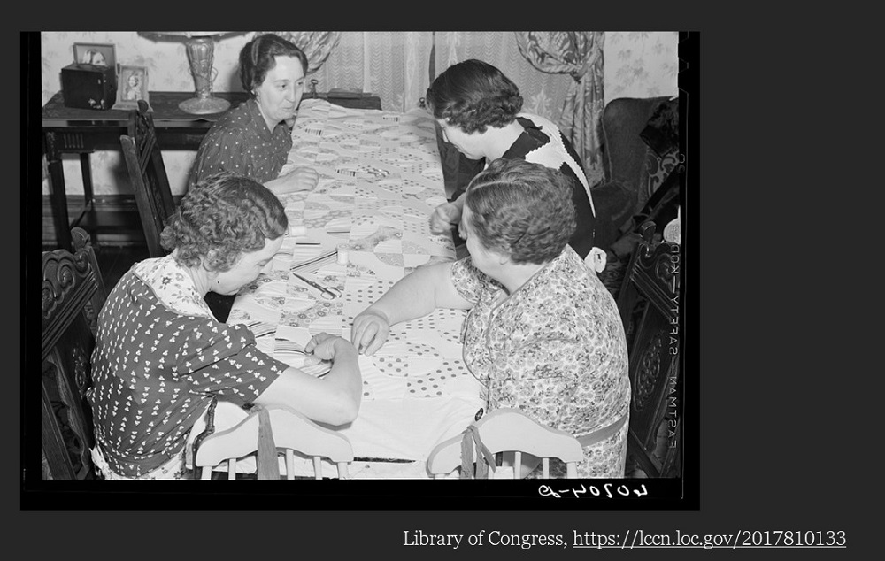 An image of four middle aged white women sitting around a quilting frame. LCCN 2017810133